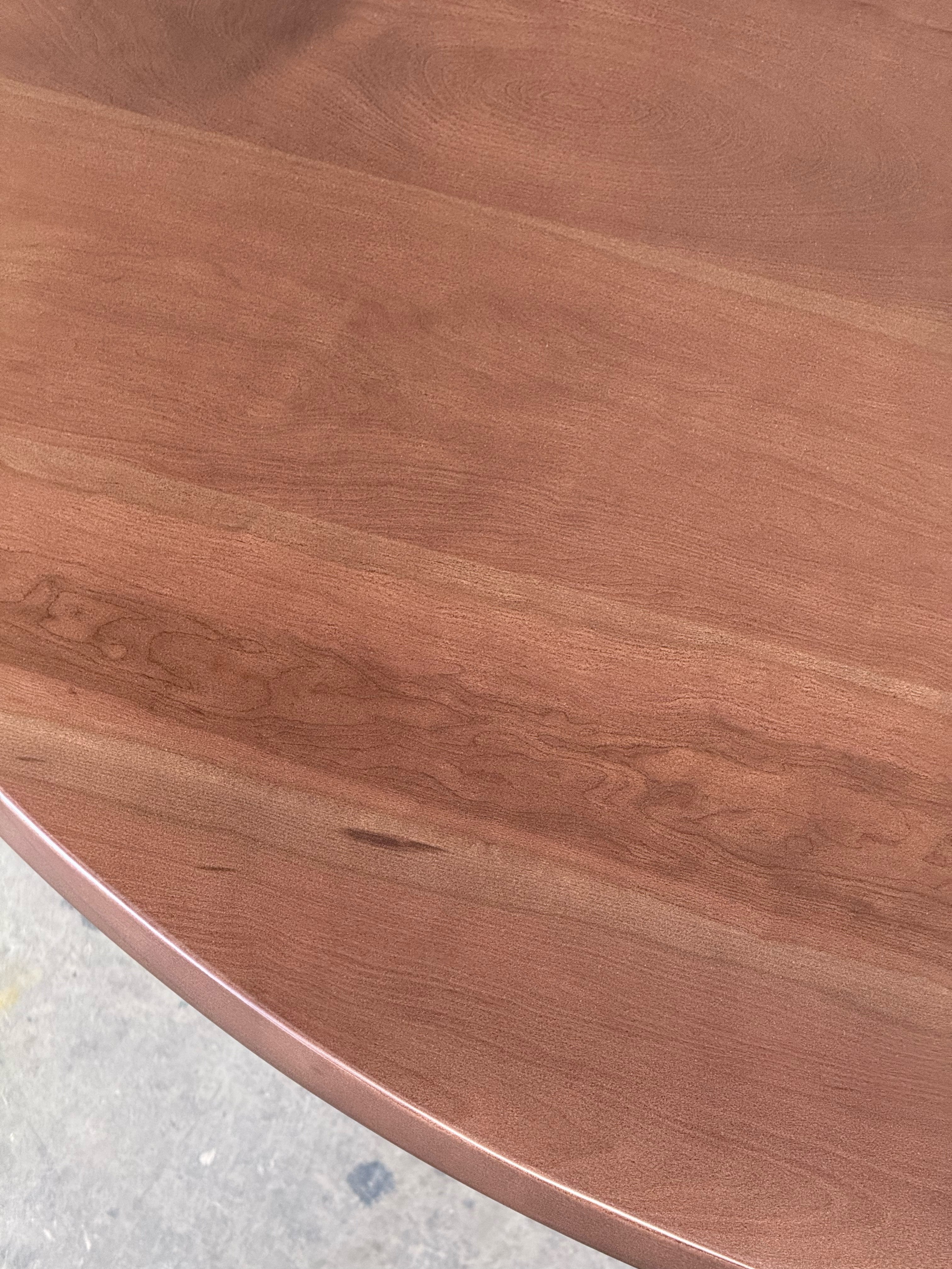 Veta de la cubierta de lenga de la mesa de comedor redonda Amora, detalle de cerca.
